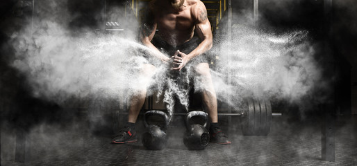 Fototapeta Muscular man workout with kettlebell at gym obraz