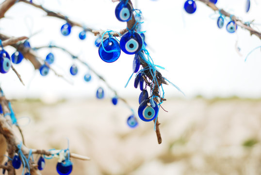 Evil-eye amulets on a branch