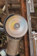 Worker cuts metal for doors at a construction site