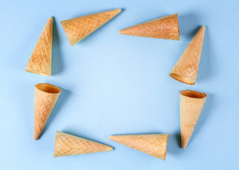 waffle ice cream cone on a blue background. place for text