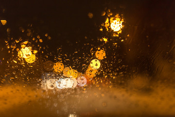 Snow with droplets on the car glass at night