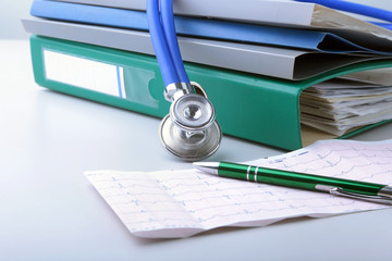 books folder file, stethoscope and RX prescription isolated on white background.