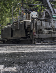 Paving applicator machine or paver at work