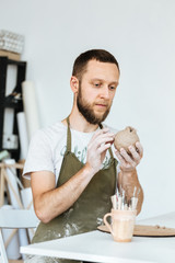Ceramics master making order of one of clients by table