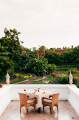 Vintage luxury dinner table set at fine dinning restaurant with nature view