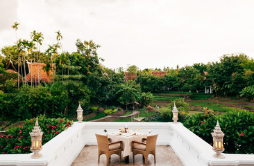 Vintage luxury dinner table set at fine dinning restaurant with nature view