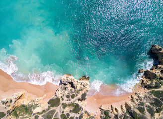 Aerial view of tropical sandy beach and ocean with turquoise water.