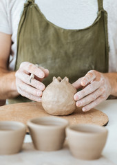 Ceramics master making order of one of clients by table
