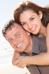 Happy smiling couple in love on beach summer vacations