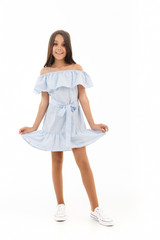 Naklejka premium Full length image of Happy young brunette girl in dress