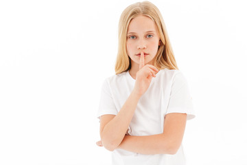 Mystery young blonde girl in casual clothes showing silence gesture