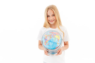 Smiling young blonde girl in casual clothes holding globe