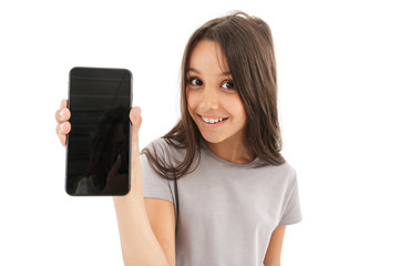 Cute girl standing isolated showing display of mobile phone.