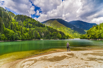 Professional photographer making a picture of a mountain lake