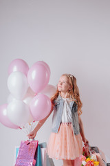 happy little girl celebrating birthday with balloons and gifts.joyful child girl on birthday party