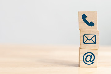 Wooden block cube symbol telephone, email, address. Website page contact us or e-mail marketing...