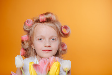 Сute little girl on morning.Happy funny child little girl with hair curlers