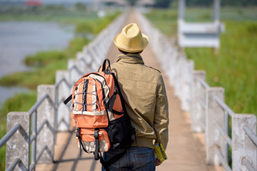 backpackers or Hikers are reading maps on the river bridge as a tourist attraction.