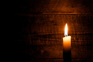 candle on old wooden background
