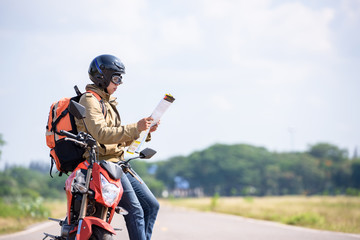 Travelers or  backpackers reading maps on motorbikes for travel.
