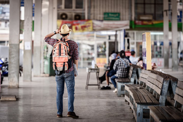 Bus station with young man are enjoying traveling.