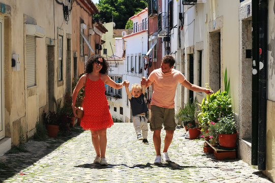 Lisbon Portugal, a young family walks through the old town