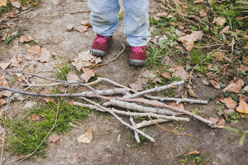 Fototapeta premium Boy playing with sticks and trunks in the forest and nature