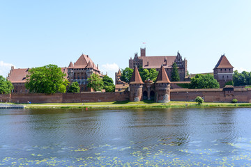 Naklejka na ściany i meble Medieval Teutonic Knights castle at Nogat river in Malbork, Poland