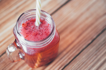 Red lemonade with raspberry on wooden table