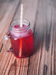 Red lemonade with raspberry on wooden table