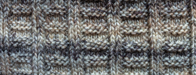 Texture of knitted background with a pattern of gray color close-up of a long banner