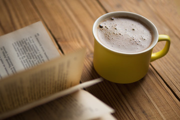 A Cup of cappuccino with a book in the cafe . vintage style