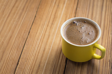 Hot coffee mug on wooden table with copyspace