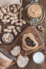 Fototapeta na wymiar Peanut Butter and Jelly Sandwich on Rustic Wooden Cutting Board