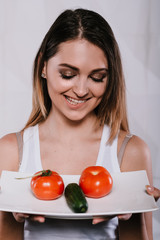 diet concept.The girl holds a plate of vegetables