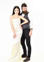 Couple in love, bride and groom in elegant clothes, white background. Bearded hipster with attractive bride dressed up for wedding ceremony. Wedding concept. Woman in wedding dress and man in vest.