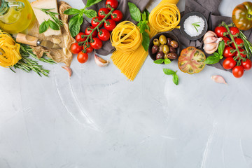 Italian food ingredients with pasta, tomatoes, cheese, olive oil, basil