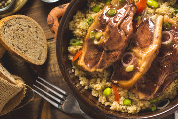 Roasted Lamb Loin Chops with Couscous and Soybean in Rustic Clay Dish