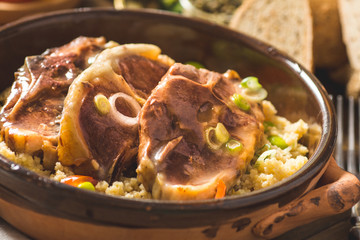 Roasted Lamb Loin Chops with Couscous and Soybean in Rustic Clay Dish