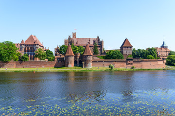 Naklejka na ściany i meble Castle at Nogat River, medieval Teutonic Knights castle in Malbork, Poland