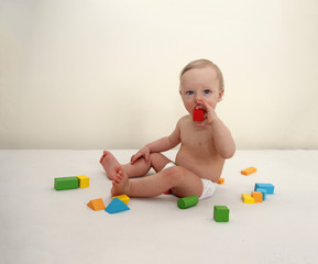 Little boy playing wooden colorful blocks