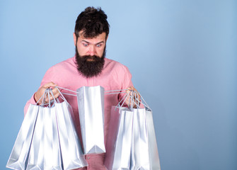 Man with trendy beard and mustache isolated on blue background. Hipster in pink shirt with...