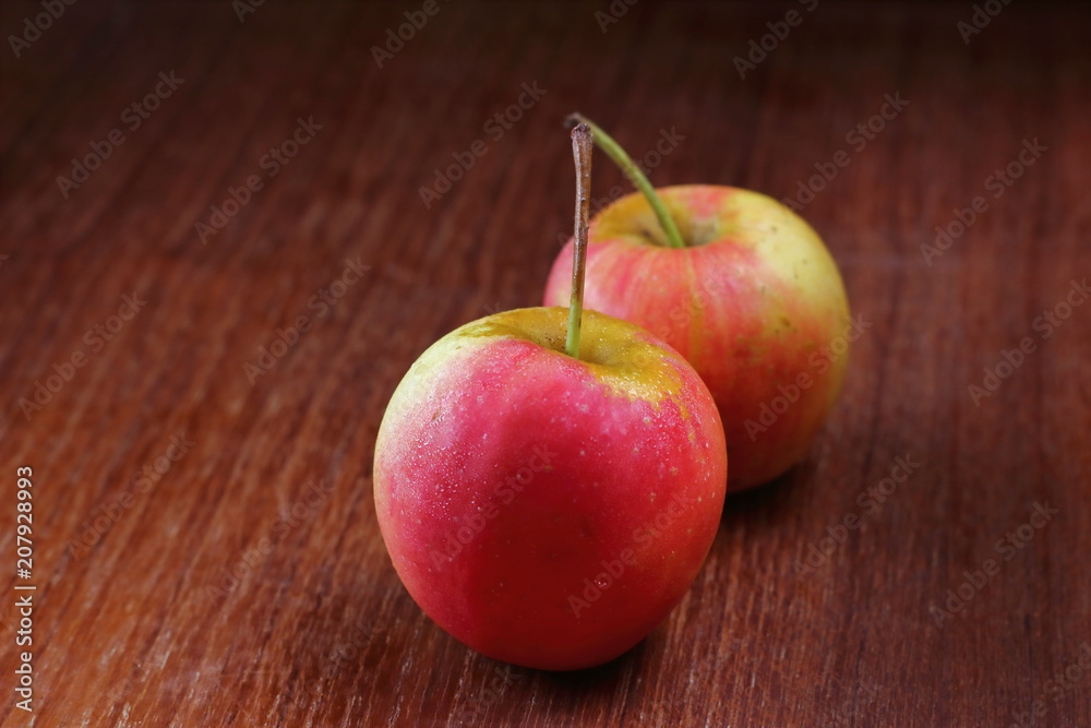 Wall mural fresh juicy red apples on old wooden