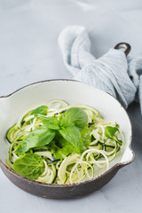 Seasonal zucchini spaghetti pasta noodles with spinach pesto sauce
