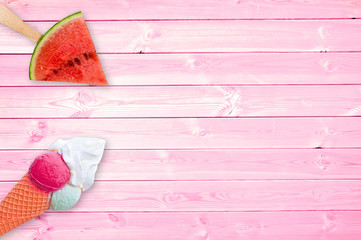 Watermelon popsicle and ice cream cone on pink planks background with copy space, summer concept