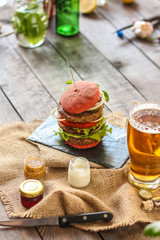 burgers on a slate plate and frothy beverage  - fast food (sandwich) - cuisine.  Food background