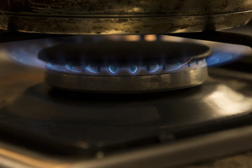 Close up of a lit gas burner on a tove top