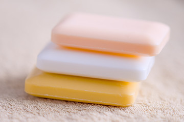 three bars of soap on a towel