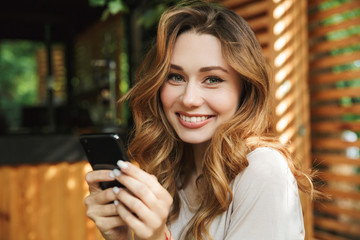 Close up portrait of a smiling young girl holding