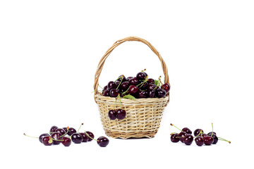 Fototapeta na wymiar .Black cherry in a small basket on a white isolated background.